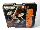 a metal case with a model of a space station inside of it