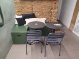 three chairs and a table in the corner of a room