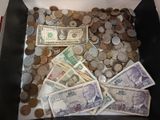 a box full of money and coins sitting on top of a table