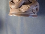 a statue of a man riding a boat on the water