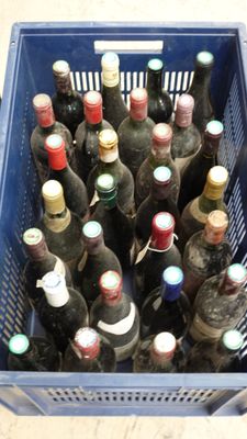 many bottles of wine in a blue basket on the floor