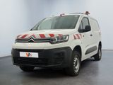 the white van is parked in a large room with a red and white stripe on the side