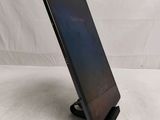 a close up of a tablet computer on a stand on a white surface