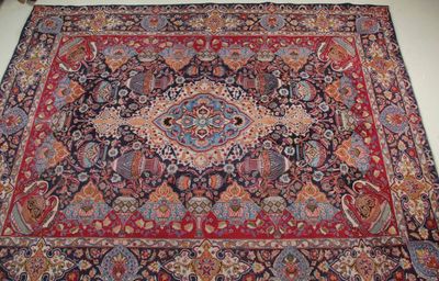 an oriental rug on a white floor with a red and blue design