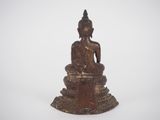 an antique bronze statue of a seated buddha on a white background