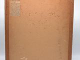 an old book with a brown cover sitting on top of a table