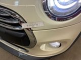 a close up of a car ' s front bumper with a sticker on it