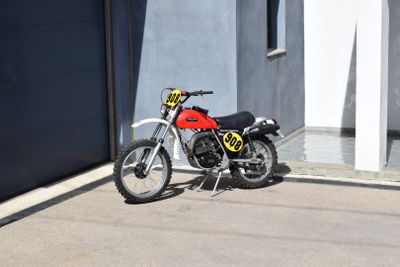 a red motorcycle parked in front of a building