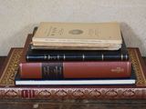 three books stacked on top of each other on a table