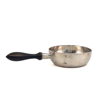 a silver pan with a black handle on a white surface