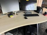 a desk with two monitors and a keyboard on it