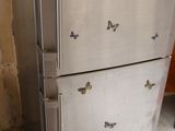 a refrigerator that has a lot of butterflies on it
