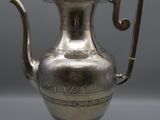 an antique silver tea pot with a handle and a handle