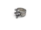 sterling silver ring with beads on a white background