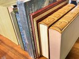 several books are stacked on top of each other on a table