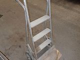 a small hand truck with a ladder in a garage