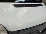 a white van parked in a garage with a window open