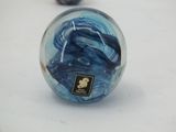 a glass ball with a picture on it sitting on a table