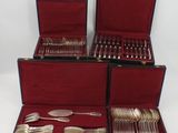 several different types of silverware in a case on a white surface