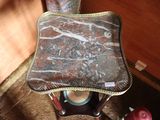 a small stool with a marbled seat on it