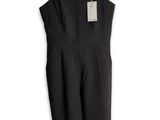 a black jumpsuit on a hanger on a white background