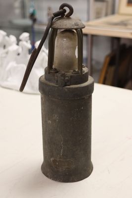 a small lantern sitting on a table in a room