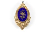 an image of a gold and blue pendant with flowers on it