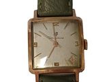 an image of a wrist watch with a green strap