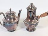 pair of antique silverplated teapots with wooden handles