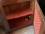 a wooden cabinet with a door open on the floor