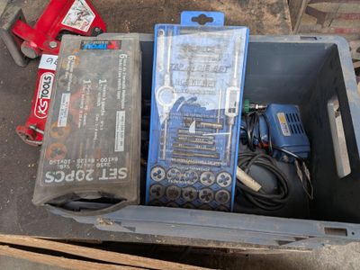 une boîte contenant des outils, posée sur le sol