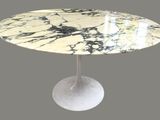 a marble table with a white base and a black and white marble top