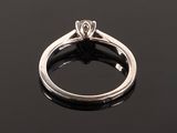 a close up view of a diamond ring on a black surface