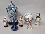 many different types of vases sitting on a table