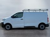 the white van is parked in a parking lot with a roof rack