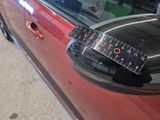 a close up of a car ' s side mirror with a speedometer on it