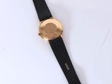 a close up of a watch on a white surface with a black strap