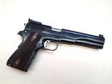 a close up of a gun on a table with a white background