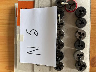 a piece of paper with a number on it next to a bunch of buttons