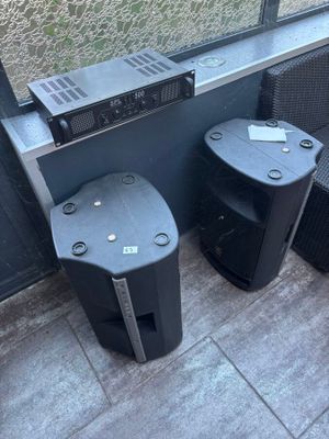 two speakers sitting next to each other on the floor
