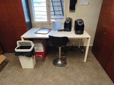 a desk with a chair and a computer on it