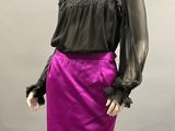 a mannequin wearing a purple skirt and black blouse