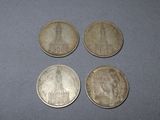 four coins sitting on top of a table next to each other