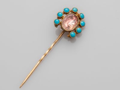 a gold, turquoise and pink stone broochle