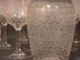 many wine glasses lined up on a table