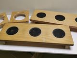 three wooden speakers sitting on top of a white table