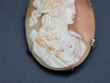 a picture of a woman in a white dress on a broocher