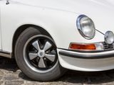 a white car parked on a cobblestone street