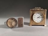 two clocks sitting next to each other on a table