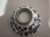 a blue and white vase sitting on a table